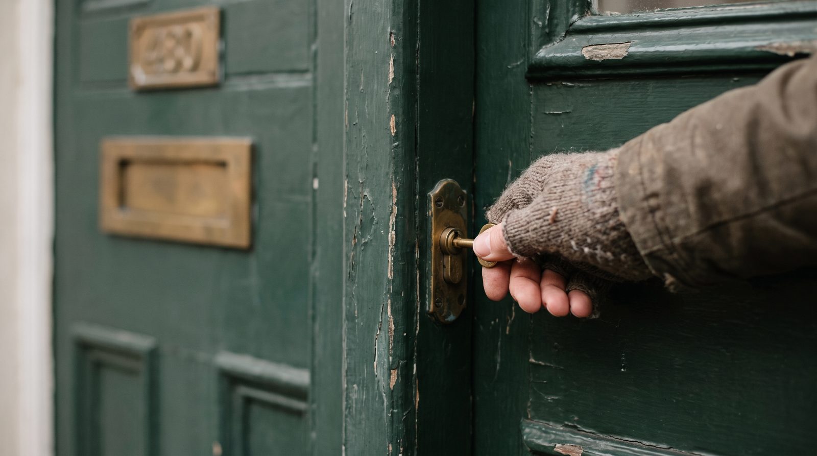 A key turning in the front door of a rental property