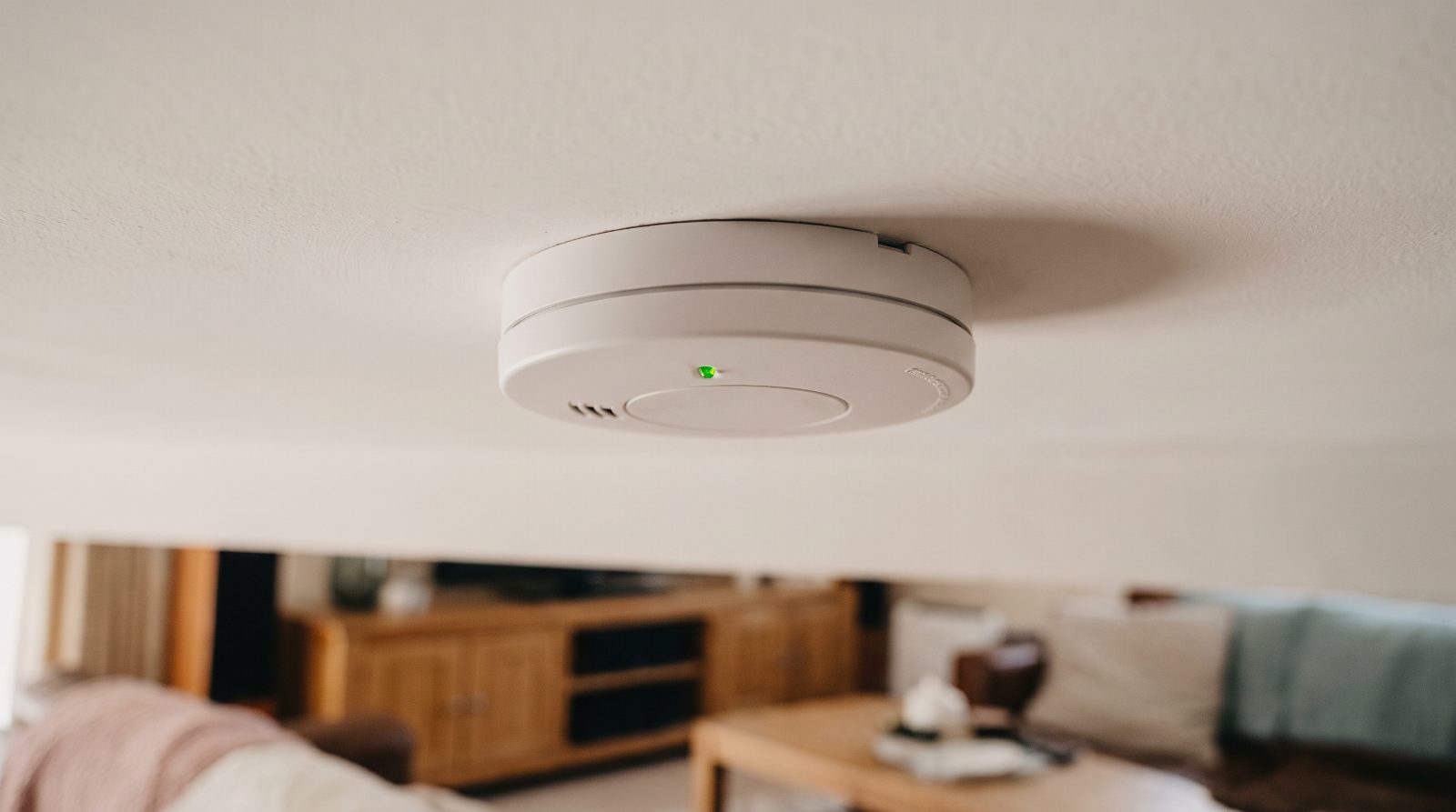 A smoke alarm fitted to the ceiling of a rental property